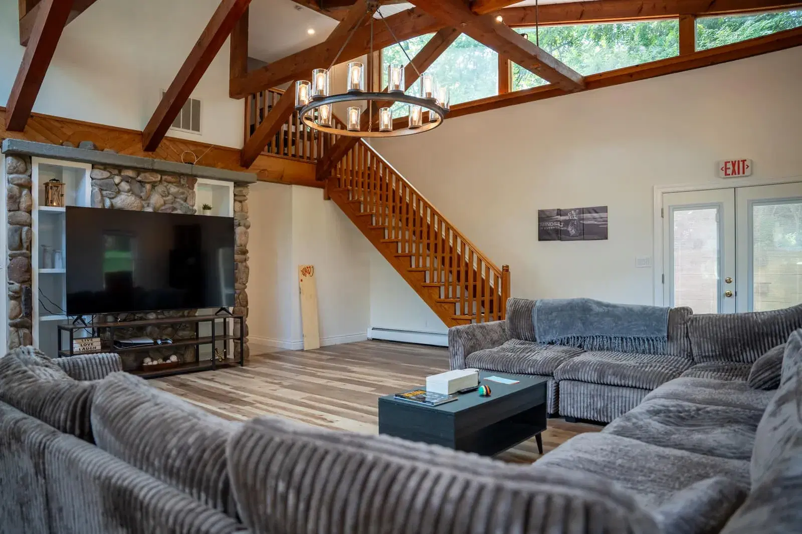 Living room in the Old Tappan house with a timber-beamed ceiling and a stone fireplace