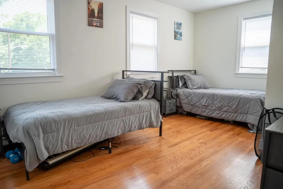 Shared bedroom with two twin beds and nightstands in the Old Tappan house