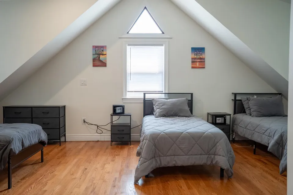 Shared bedroom with twin beds under the peaked roof of the Old Tappan house