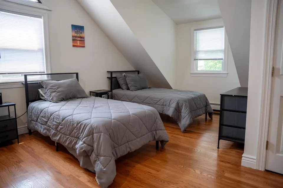 Shared bedroom with two twin beds in the Old Tappan sober living home