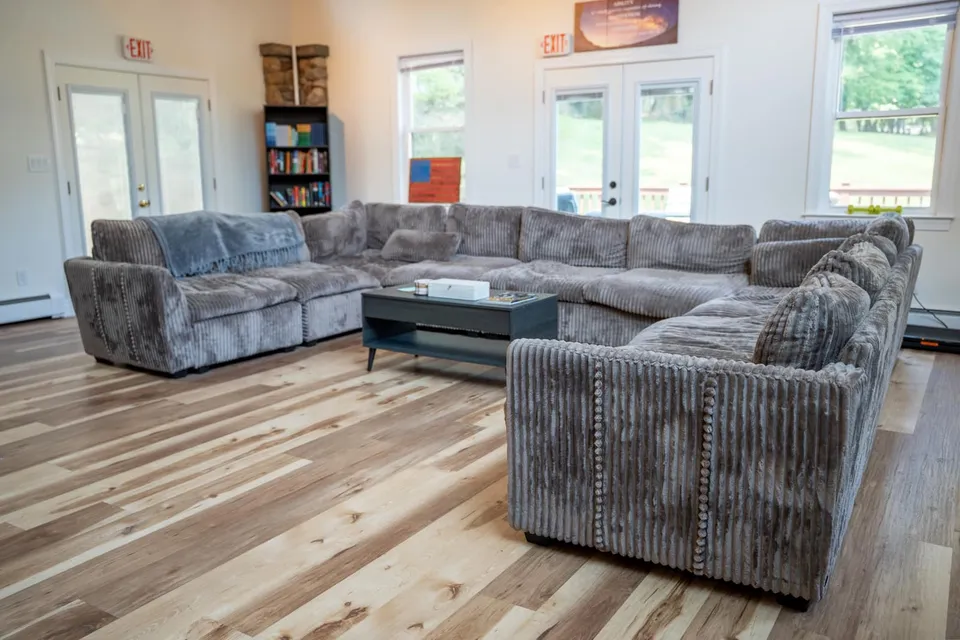 Living room with a large sectional sofa in the Old Tappan house